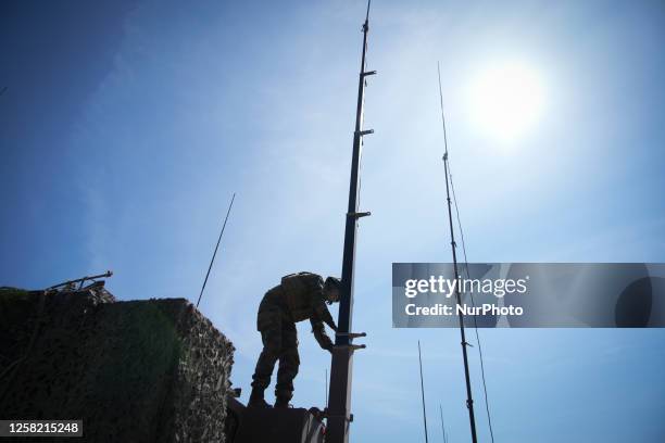 Soldier is seen holding a communications antenna near Tapa, Estonia on 20 May, 2023. Estonia is hosting the Spring Storm NATO exercises involving...