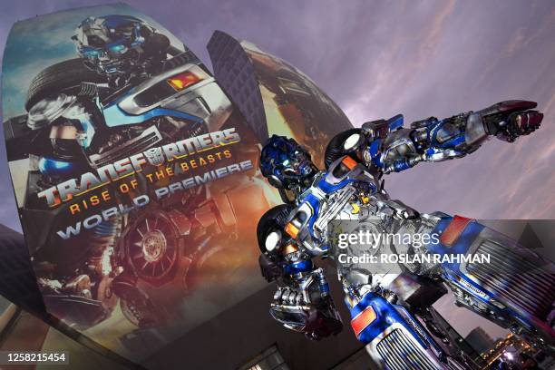 Life-size transformer robot character named Mirage stands at red carpet photo calls during world premier "Transformers: Rise of the Beasts" at Marina...