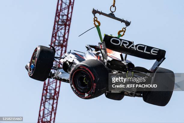 Red Bull Racing's Mexican driver Sergio Perez is removed from the track after he crashed during a qualifying session of the Formula One Monaco Grand...