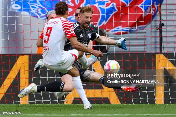 Leipzig's Danish forward Yussuf Poulsen scores the 3-2 goal past Schalke's German goalkeeper Ralf Faehrmann during the German first division...