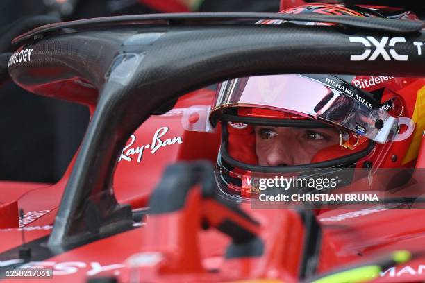 Ferrari's Spanish driver Carlos Sainz Jr sits in his car in the pits during a qualifying session of the Formula One Monaco Grand Prix at the Monaco...