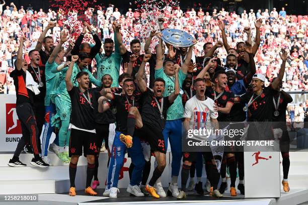 Bayern Munich's players celebrate with the trophy after the German first division Bundesliga football match between FC Cologne and FC Bayern Munich...