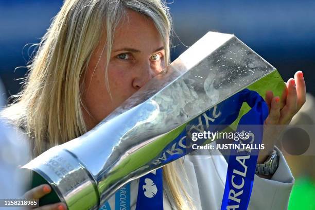 Chelsea's English manager Emma Hayes kisses the trophy as Chelsea's players celebrate winning the title after the English Women's Super League...