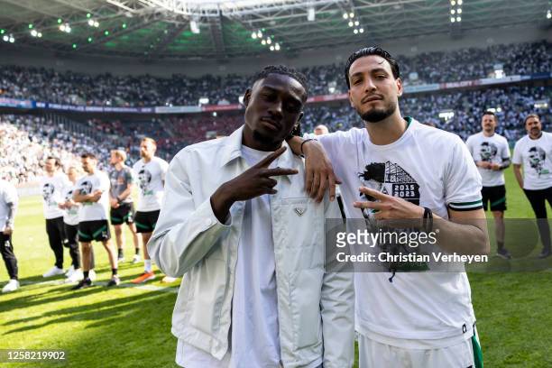 Manu Kone and Ramy Bensebaini of Borussia Moenchengladbach are seen after the Bundesliga match between Borussia Moenchengladbach and FC Augsburg at...