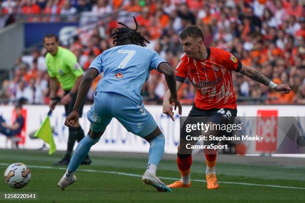 Luton Town's Alfie Doughty crosses the ball despite the attentions of Coventry City's Brooke Norton-Cuffy during the Sky Bet Championship Play Off...