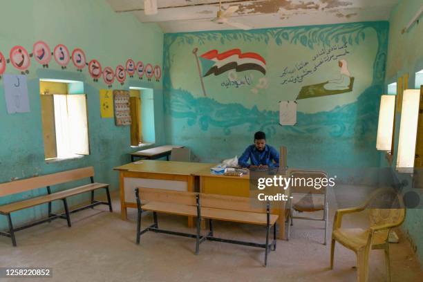 Sudanese volunteer works at a makeshift emergency room set-up in a school building in Omdurman, the capital's twin city, on May 27 amid ongoing...