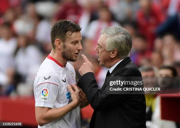 Sevilla's Croatian midfielder Ivan Rakitic speaks with Real Madrid's Italian coach Carlo Ancelotti during the Spanish league football match between...