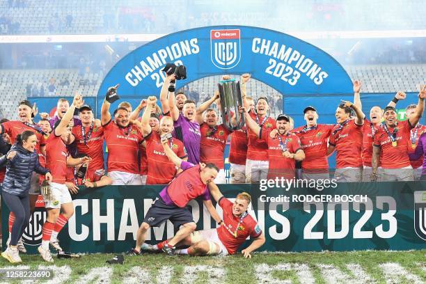 Munster players celebrate with the trophy after they won the United Rugby Championship final match between the Stormers and Munster at the Cape Town...