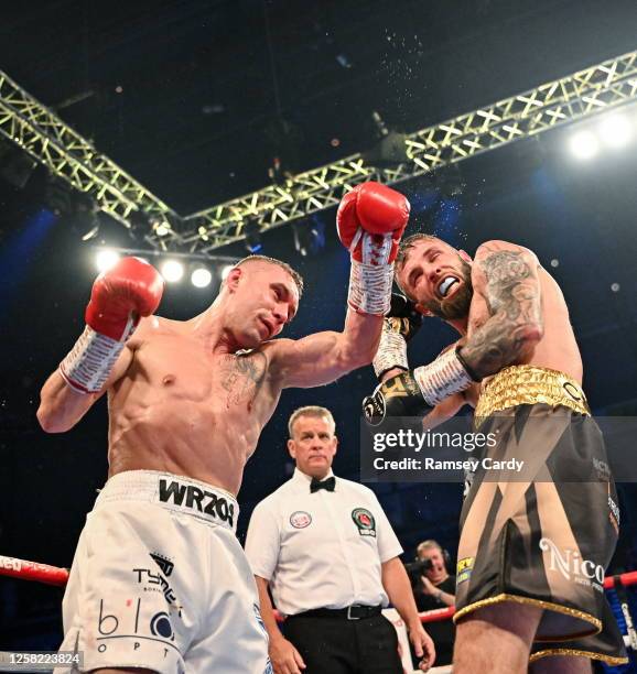 Belfast , United Kingdom - 27 May 2023; Anthony Cacace, right, in action against Damian Wrzesinski during their IBO World Super-Featherweight title...