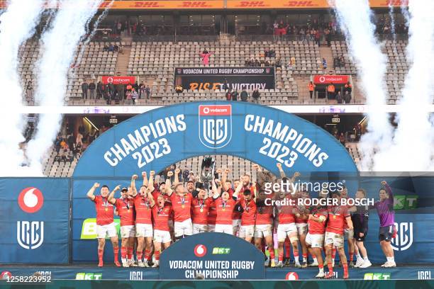 Munster players celebrate with the trophy after they won the United Rugby Championship final match between the Stormers and Munster at the Cape Town...