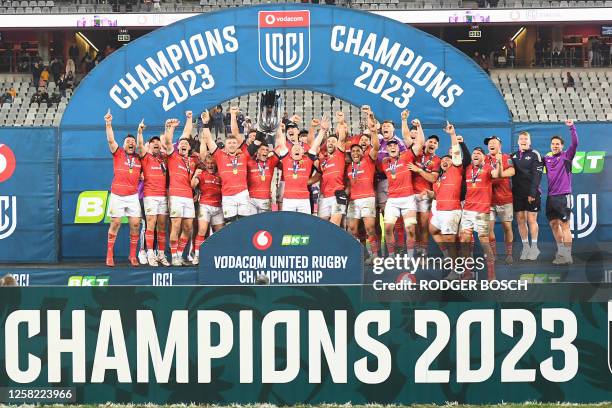 Munster players celebrate with the trophy after they won the United Rugby Championship final match between the Stormers and Munster at the Cape Town...