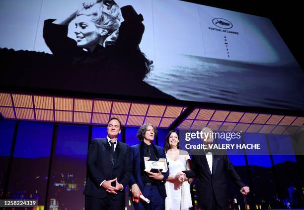 British director Jonathan Glazer stands next to US director Quentin Tarantino and US film director and producer Roger Corman after he was awarded...