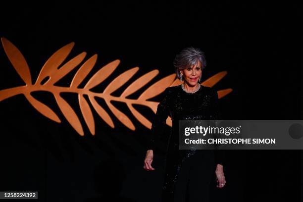 Actress Jane Fonda arrives on stage to award the Palme d'Or during the closing ceremony of the 76th edition of the Cannes Film Festival in Cannes,...