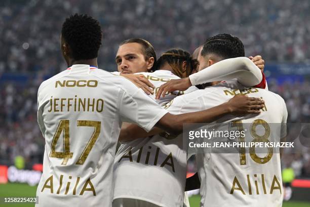 Lyon's players celebrate after scoring a goal during the French L1 football match between Olympique Lyonnais and Stade de Reims at The Groupama...
