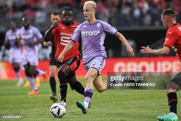 Rennes' Belgian forward Jeremy Doku fights for the ball with Monaco's Russian midfielder Aleksandr Golovin during the French L1 football match...