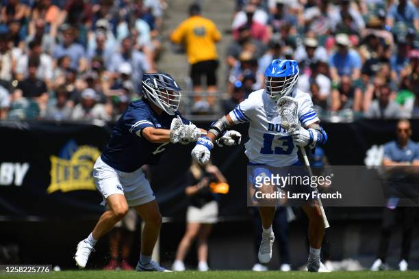 Grant Haus of the Penn State Nittany Lions defends Owen Caputo of the Duke University Blue Devils during the Division I Men's Lacrosse Semifinals...