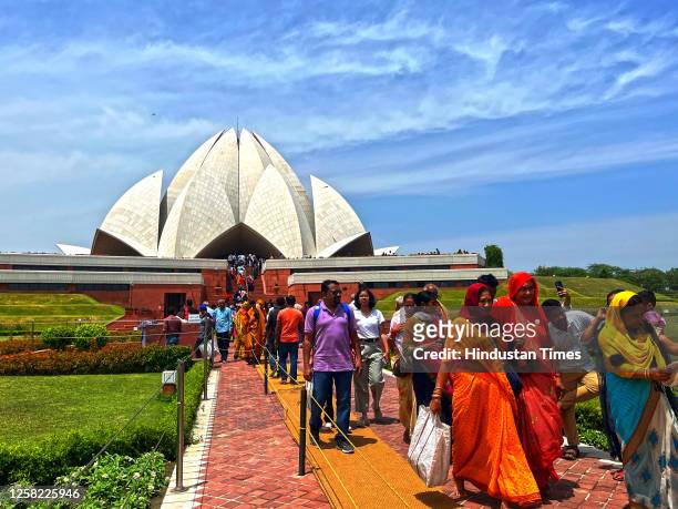 People visit Lotus Temple, after rain under cloudy shades, on May 27, 2023 in New Delhi, India.
