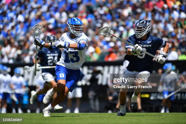 Owen Caputo of the Duke University Blue Devils runs with the ball while Sam Sweeney of the Penn State Nittany Lions defends during the Division I...