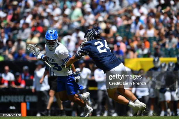 Owen Caputo of the Duke University Blue Devils runs with the ball while Kyle Aldridge of the Penn State Nittany Lions defends during the Division I...