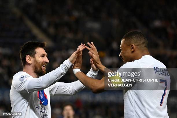 Paris Saint-Germain's Argentine forward Lionel Messi celebrates with Paris Saint-Germain's French forward Kylian Mbappe after scoring his team's...