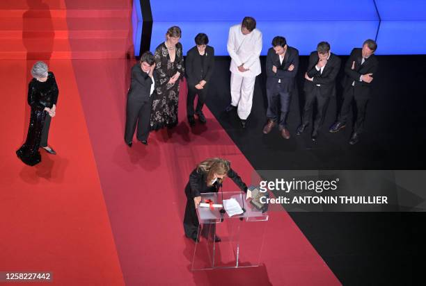 French director Justine Triet delivers a speech surrounded by US actress Jane Fonda , German actress Sandra Hueller , actor Milo Machado Graner ,...