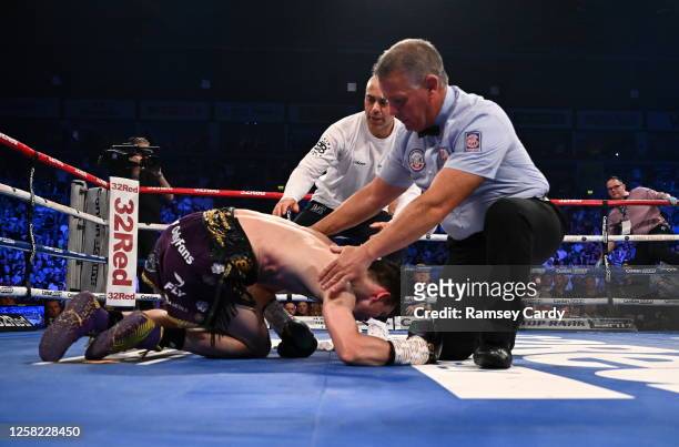 Belfast , United Kingdom - 27 May 2023; Michael Conlan after being knocked down by Luis Alberto Lopez during their IBF Featherweight World Title bout...