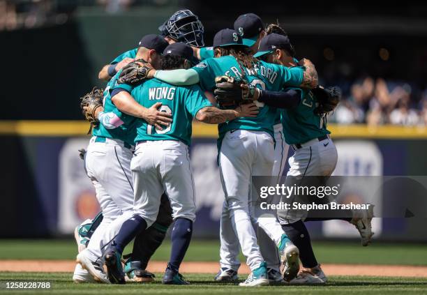 From left, Ty France of the Seattle Mariners, Kolten Wong, J.P. Crawford and Jose Caballero celebrate after a game against the Pittsburgh Pirates at...