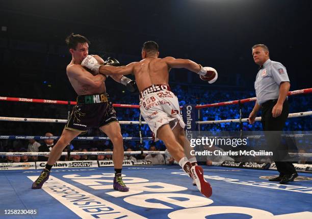 Michael Conlan is punched by Luis Alberto Lopez during their IBF world featherweight title fight at The SSE Arena Belfast on May 27, 2023 in Belfast,...
