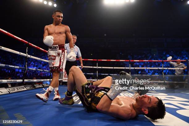 Michael Conlan is knocked down by Luis Alberto Lopez during their IBF world featherweight title fight at The SSE Arena Belfast on May 27, 2023 in...