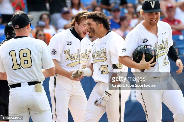 Vanderbilt Commodores catcher Alan Espinal celebrates with teammates after scoring in the 2023 SEC Baseball Tournament game between the Florida...