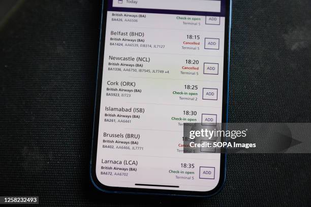 In this photo illustration the Heathrow Airport App displays British Airways flight cancellations on the screen of a smart phone in London. British...