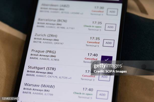 In this photo illustration the Heathrow Airport App displays British Airways flight cancellations on the screen of a smart phone in London. British...