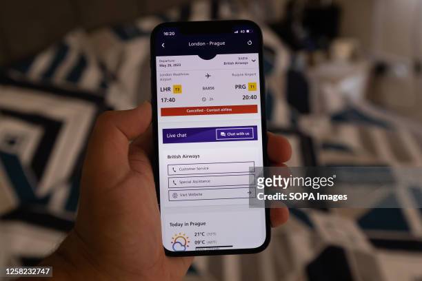 In this photo illustration the Heathrow Airport App displays British Airways flight cancellations on the screen of a smart phone in London. British...