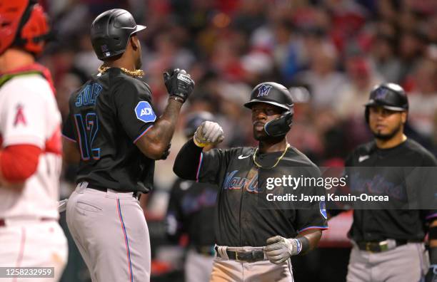 Jorge Soler of the Miami Marlins celebrates with Jonathan Davis after hitting a two-run home run in the seventh inning against the Los Angeles Angels...