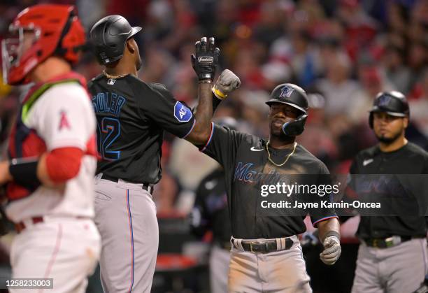 Jorge Soler of the Miami Marlins celebrates with Jonathan Davis after hitting a two-run home run in the seventh inning against the Los Angeles Angels...