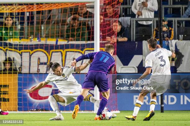 Martín Cáceres of Los Angeles Galaxy defends against Karol Widerski of Charlotte FC during the game at Dignity Health Sports Park on May 27, 2023 in...