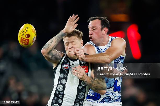 Todd Goldstein of the Kangaroos handpasses the ball ahead of Jordan De Goey of the Magpies during the 2023 AFL Round 11 match between the Collingwood...
