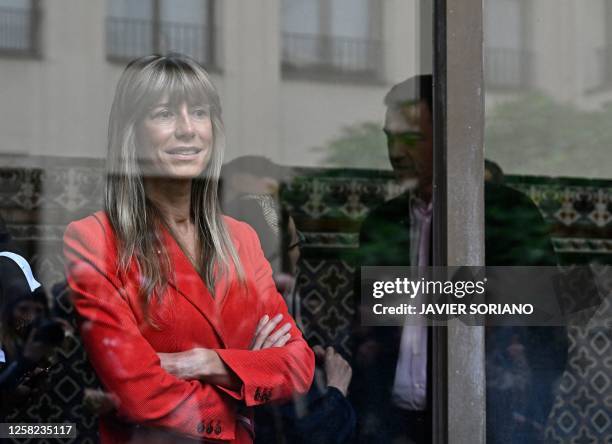 Begona Gomez wife of Spain's Prime minister Pedro Sanchez of Socialist Party is seen behind a window after casting her ballots in Madrid on May 28,...