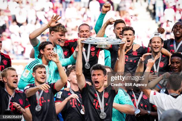 Thomas Muller of FC Bayern Munchen celebrates with the Bundesliga Meisterschale trophy following winning the Bundeliga title after the Bundesliga...