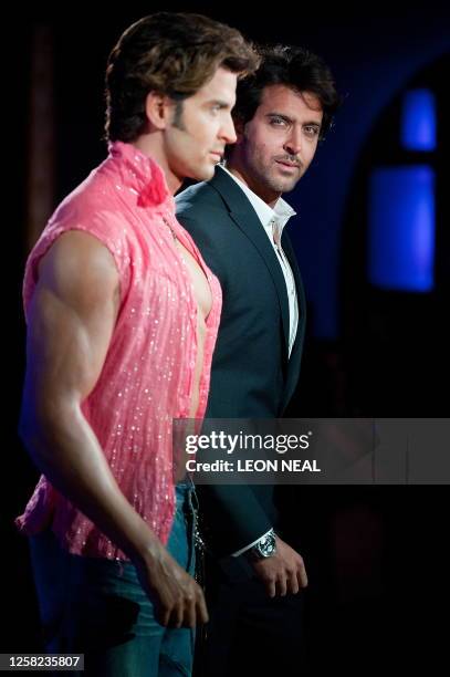 Bollywood actor Hrithik Roshan poses with a wax figure of himself as it is unveiled at the Madame Tussauds waxwork museum in central London, on...