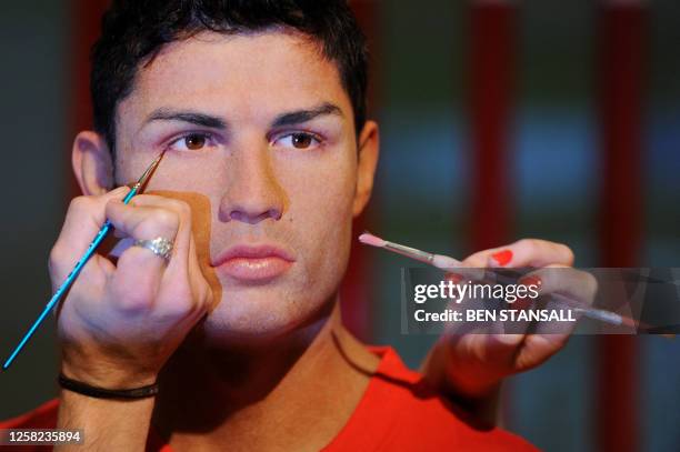 Wax model of Portuguese footballer Cristiano Ronaldo is unveiled during a photocall at Madame Tussauds museum in London, on June 9, 2010. AFP...