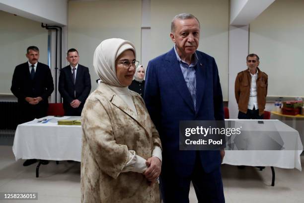 Turkish President Recep Tayyip Erdogan and his wife Emine Erdogan arrive at a polling station to cast their vote during the Turkish presidential...