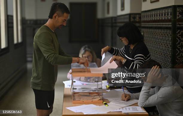 Spanish citizens cast their votes for his vote for the local election at a polling station in Madrid, Spain on May 28, 2023.