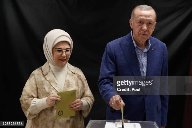 Turkish President Recep Tayyip Erdogan and his wife Emine Erdogan arrive at a polling station to cast their vote during the Turkish presidential...