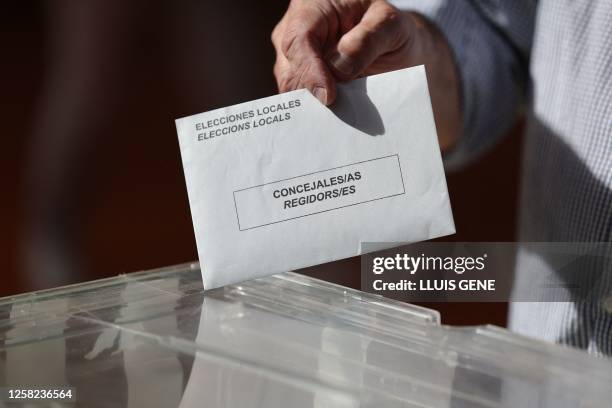 Voter casts his ballot at the polling station in Barcelona, on May 28, 2023 during local and regional polls. Spain's local and regional elections...