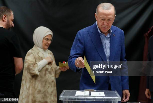 Turkish President Recep Tayyip Erdogan and his wife Emine Erdogan arrive at a polling station to cast their vote during the Turkish presidential...