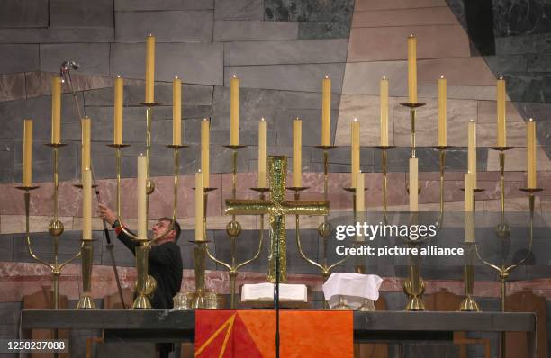 May 2023, Bavaria, Munich: Candles are lit before the start of a festive service at St. Matthew's Lutheran parish church. Christians in Bavaria...