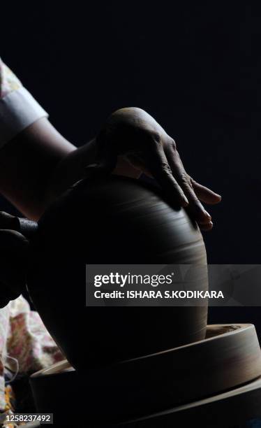 Sri Lankan woman makes earthenware at a pottery factory in the Colombo suburb of Kaduwela on March 7, 2010. Sri Lanka marks International Women's Day...