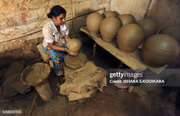 Sri Lankan woman makes earthenware at a pottery factory in the Colombo suburb of Kaduwela on March 7, 2010. Sri Lanka marks International Women's Day...