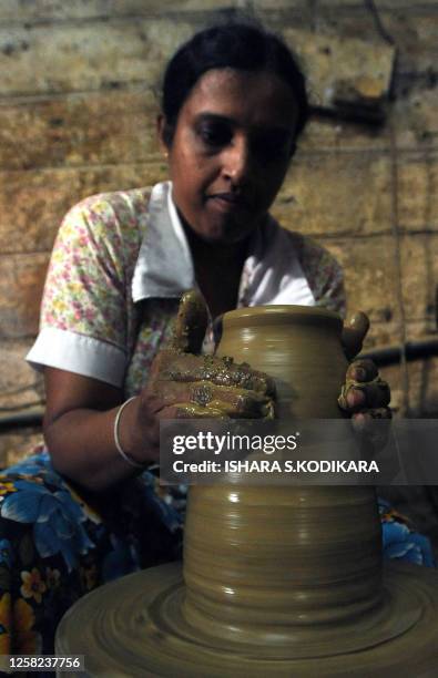 Sri Lankan woman makes earthenware at a pottery factory in the Colombo suburb of Kaduwela on March 7, 2010. Sri Lanka marks International Women's Day...